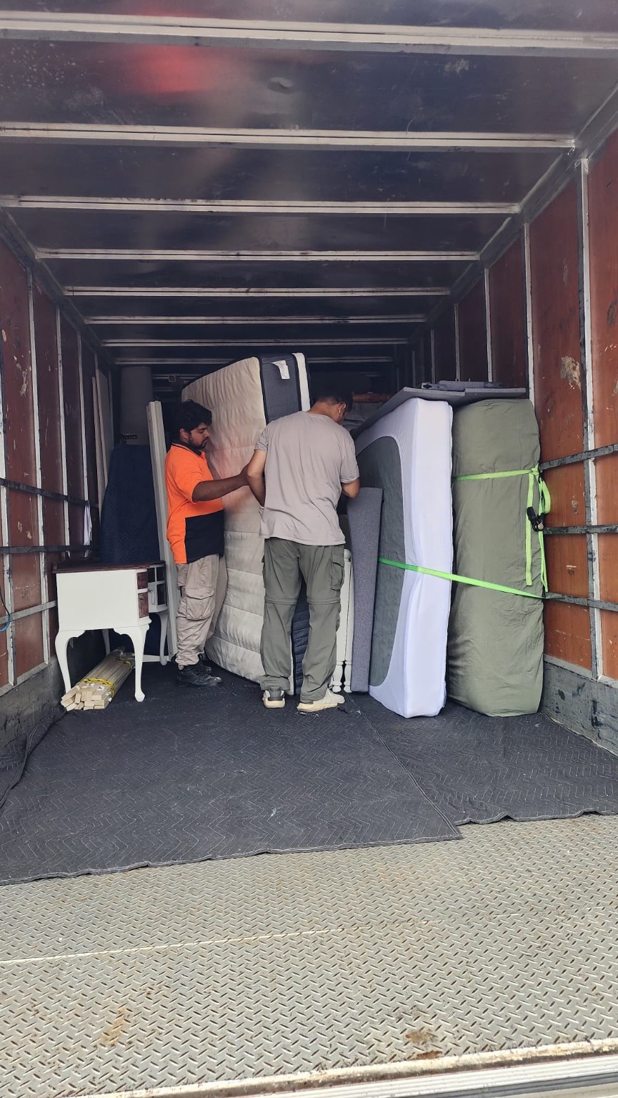 ATS moving team securing furniture inside a moving truck